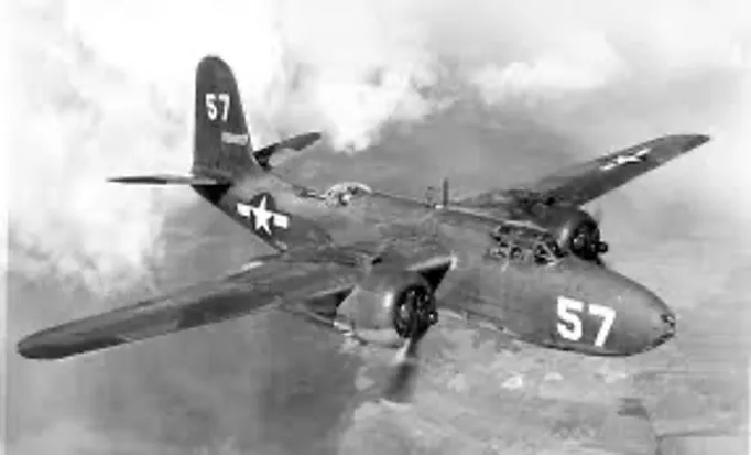 A vintage military aircraft in flight marked with the number 57.